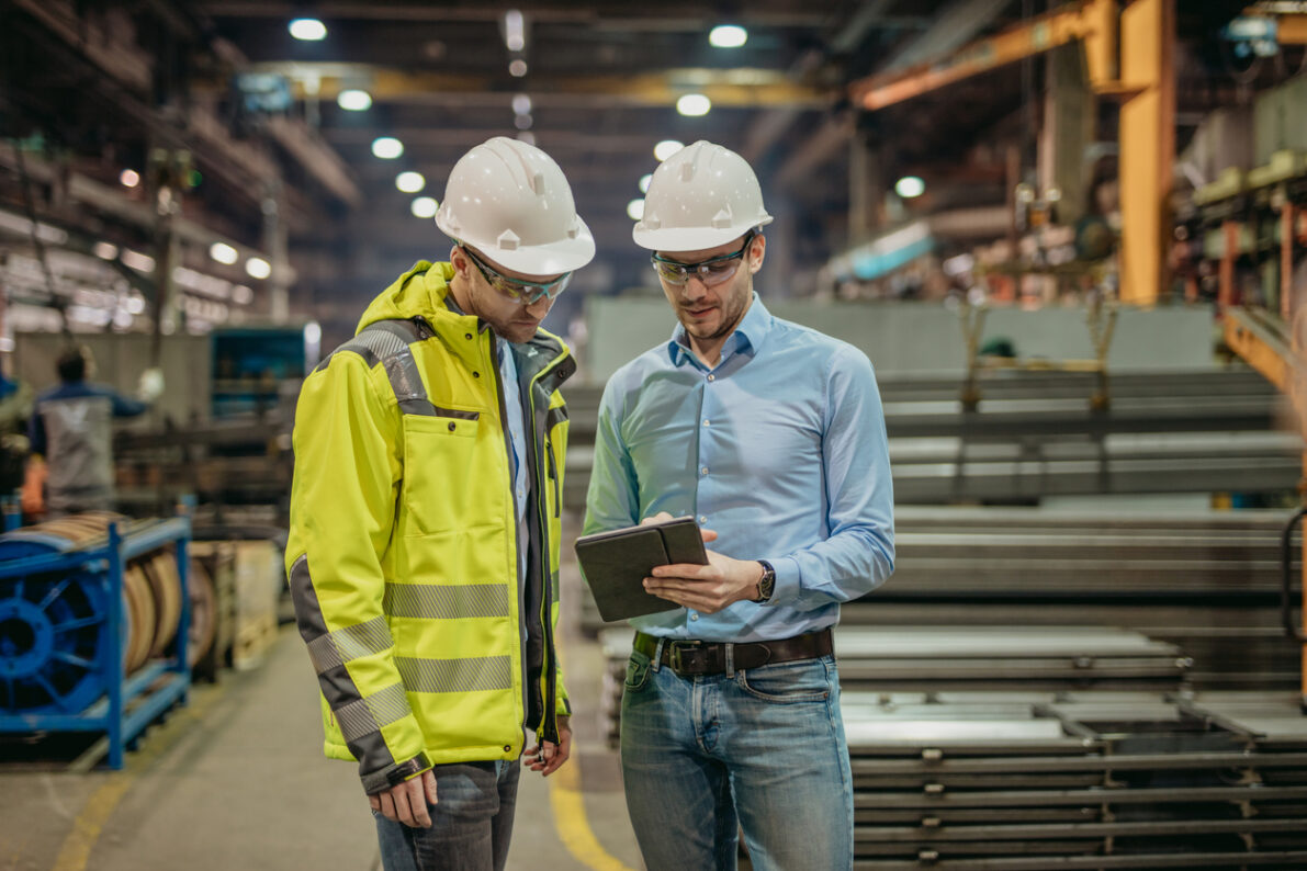 Two Adult discussing work together on digital tablet